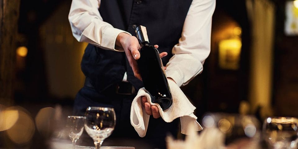 server presenting a bottle of wine