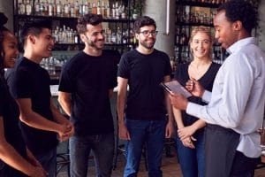 restaurant manager briefing the staff