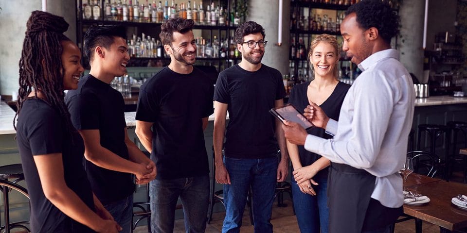 restaurant manager briefing the staff