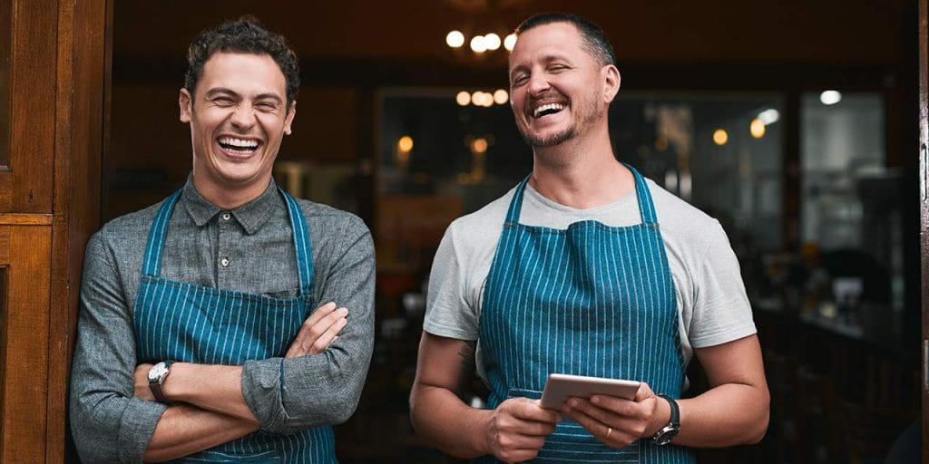 restaurant owners smiling