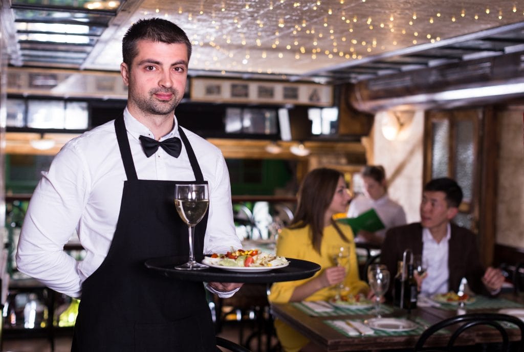 fine dining server wearing a black apron