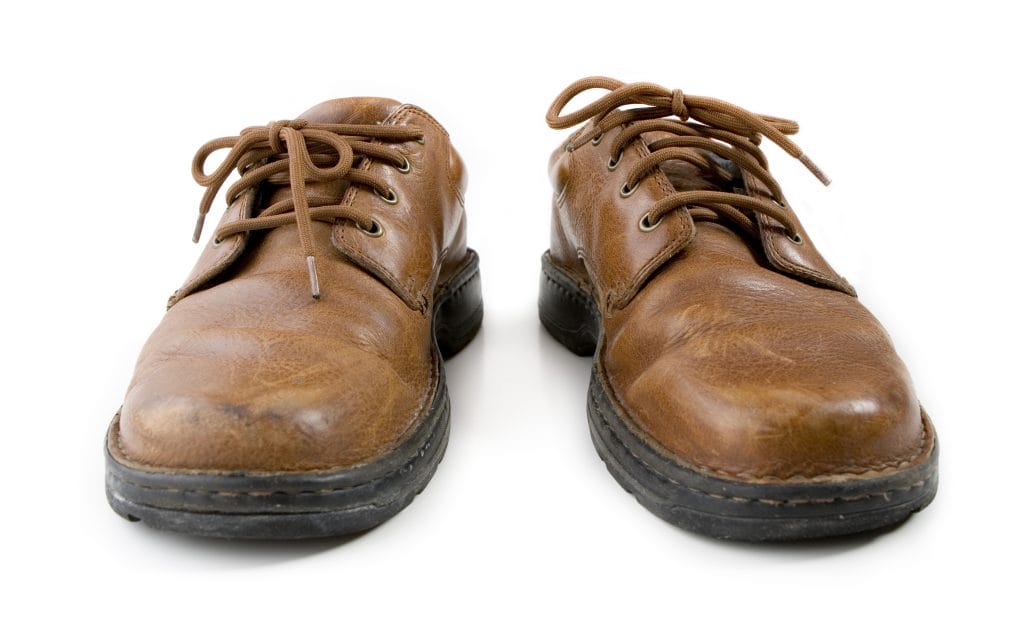 worn out brown leather shoes