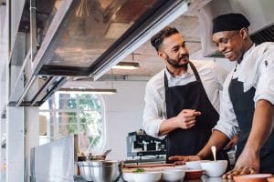 chefs in kitchen talking