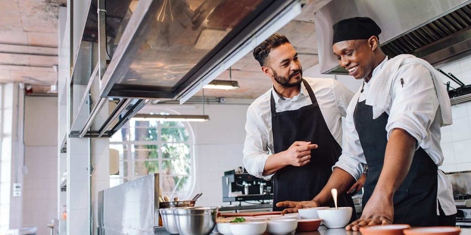 chefs in kitchen talking