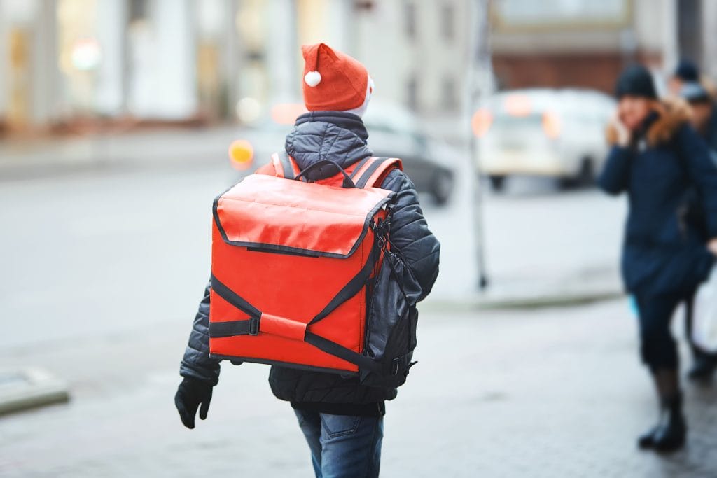 delivery man wearing a Santa hat