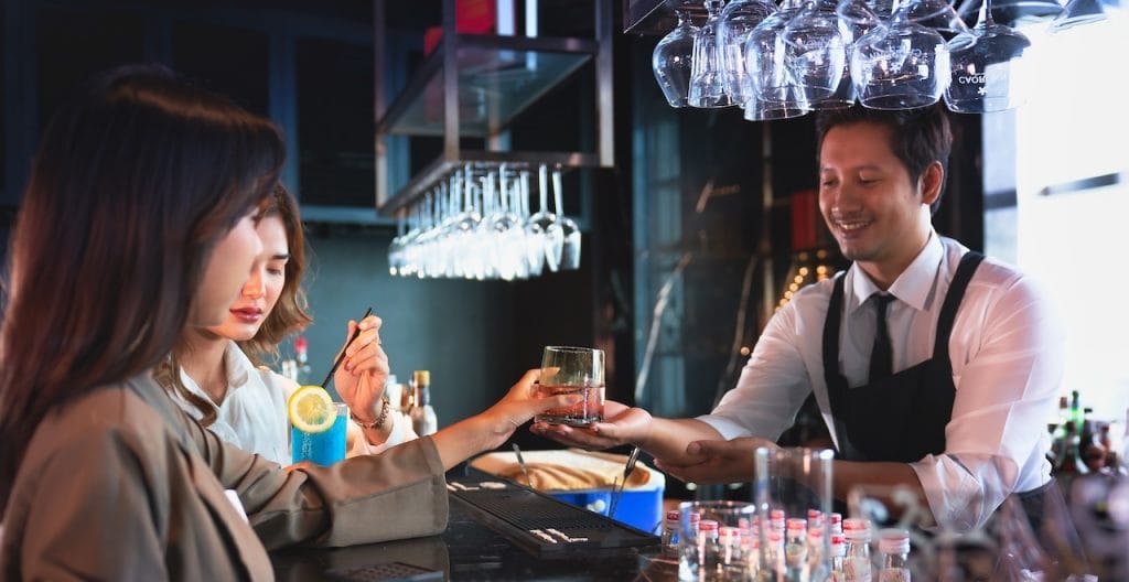 bartender talking to customers