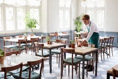 waiter clearing up a table