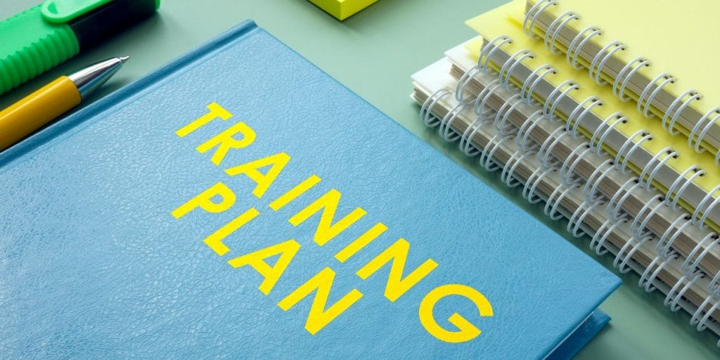 'training plan' written on a blue notebook