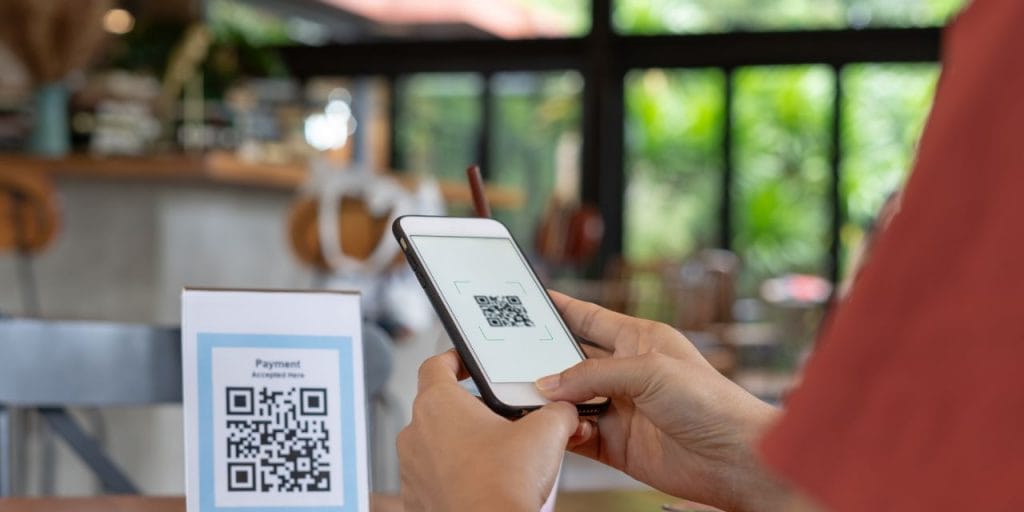 person scanning a QR code with their mobile phone