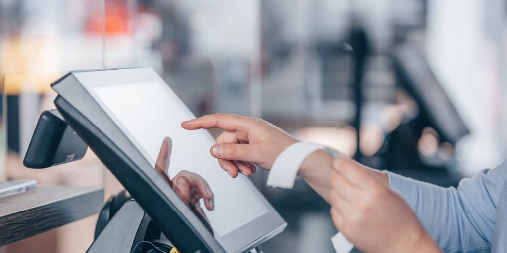 hands typing on a POS screen; restaurant challenges 2025