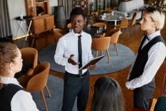 assistant restaurant manager talking to staff