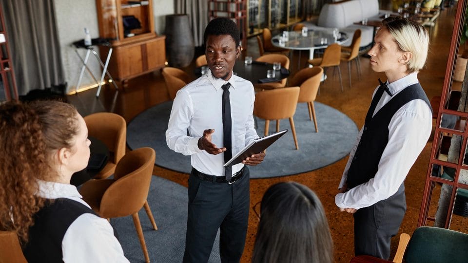 assistant restaurant manager talking to staff