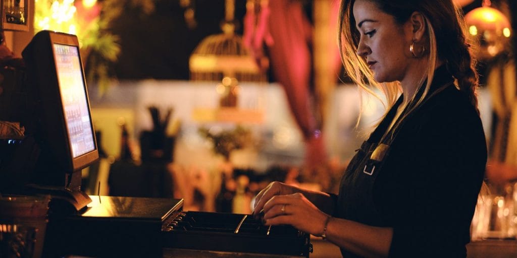 a bartender operating a POS