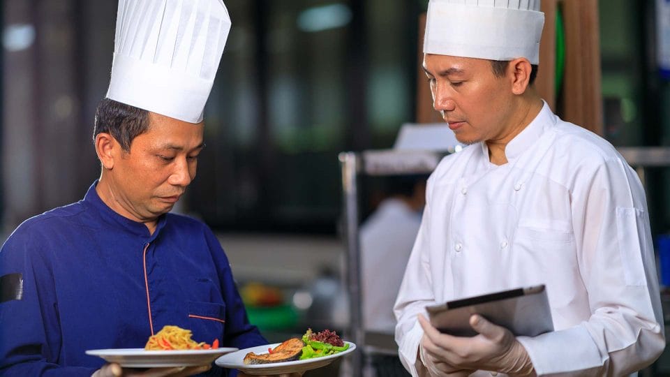 executive chef inspecting dish