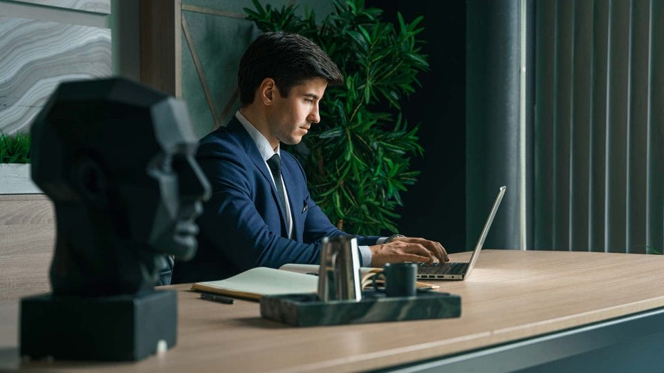 hotel gm working on laptop