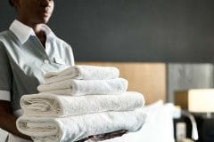 housekeeper holding towels