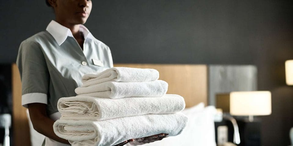 housekeeper holding towels