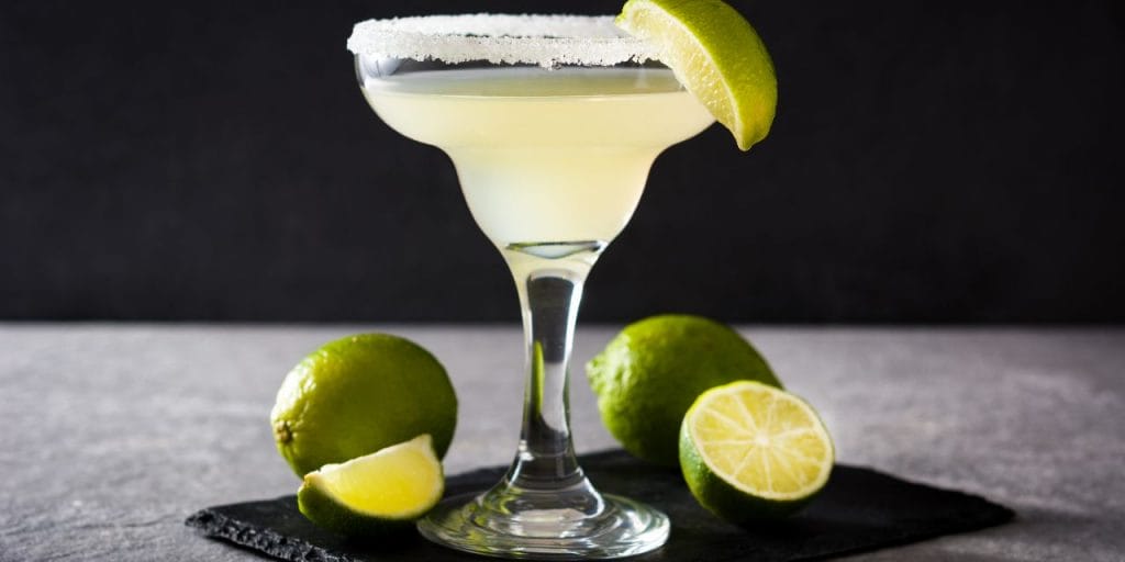 a cocktail served with lime