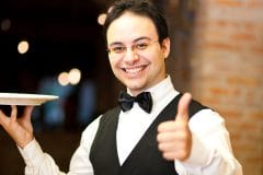 smiling server showing thumbs up