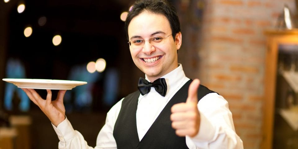 smiling server showing thumbs up