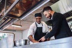 kitchen manager talking with chef