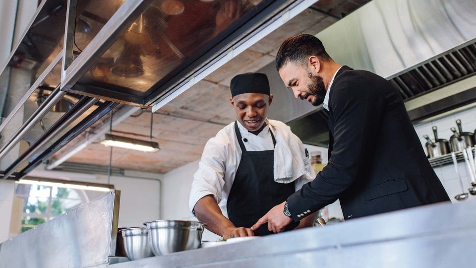 kitchen manager talking with chef