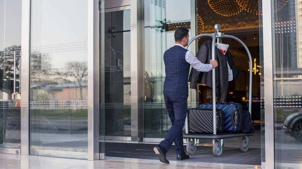 bellhop pushing luggage card